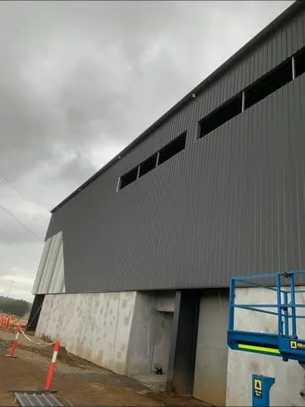 Large industrial building with dark wall sheeting