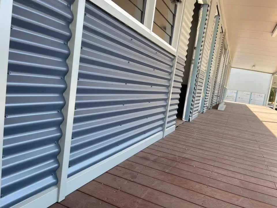 Corrugated cladding along a modular building veranda