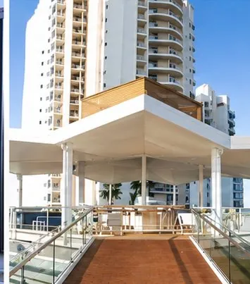 White roofed pavilion at the base of a residential tower