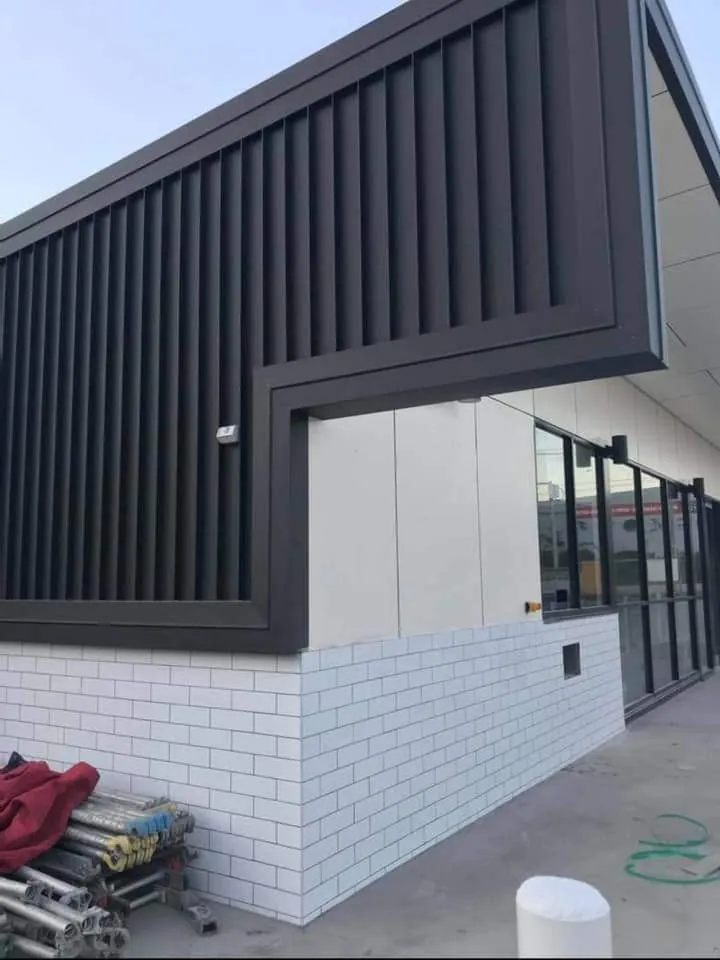 Black vertical rib cladding on a service station