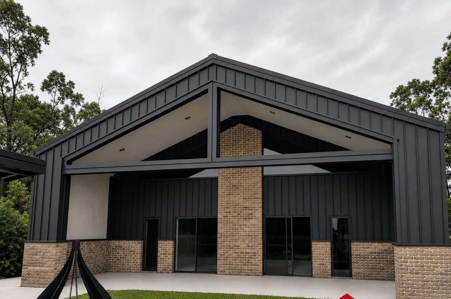 Black standing seam gable pavilion with brick piers