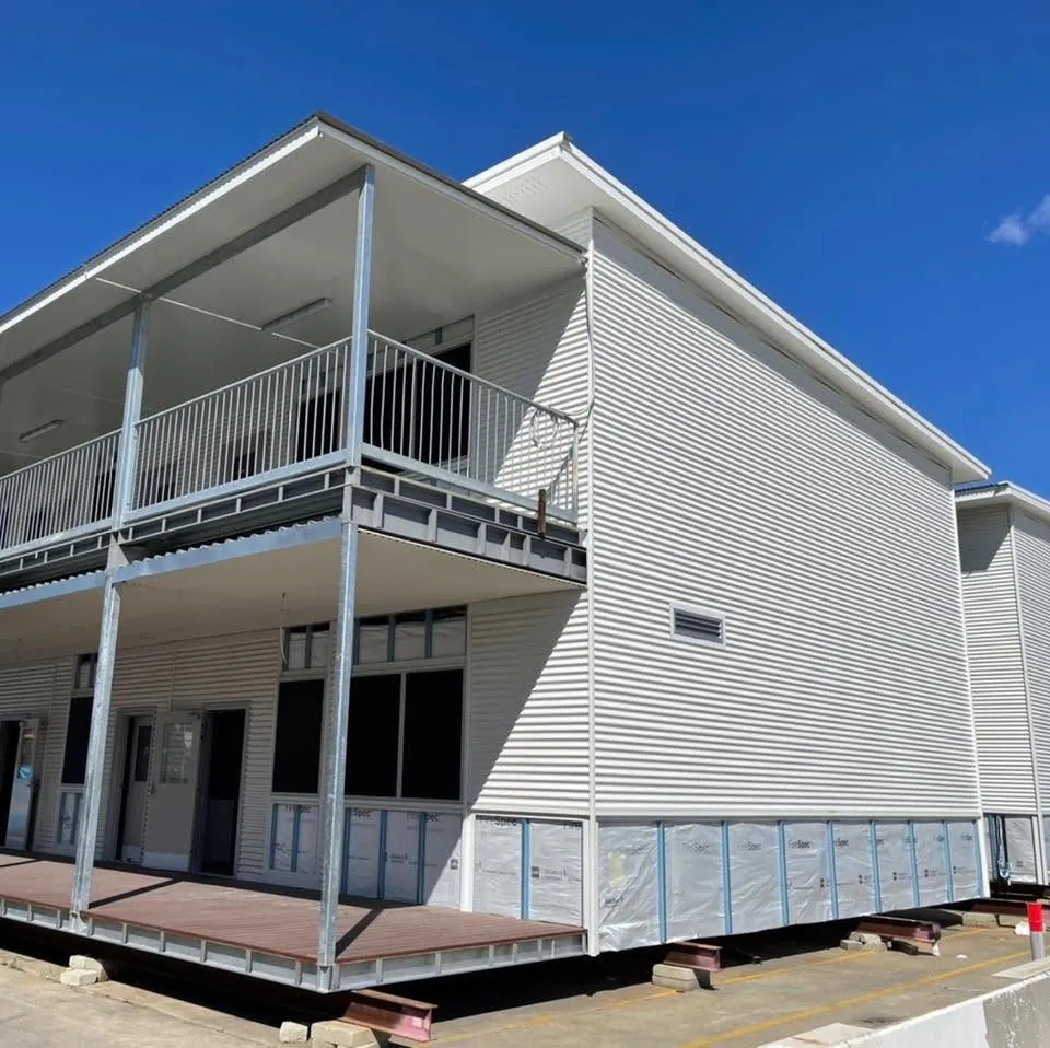 Two-storey modular building clad in white corrugated steel